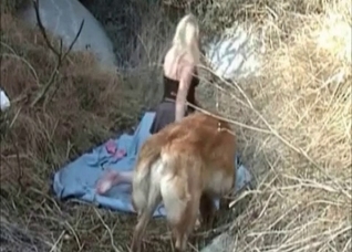 Young teen teasing dog outdoors